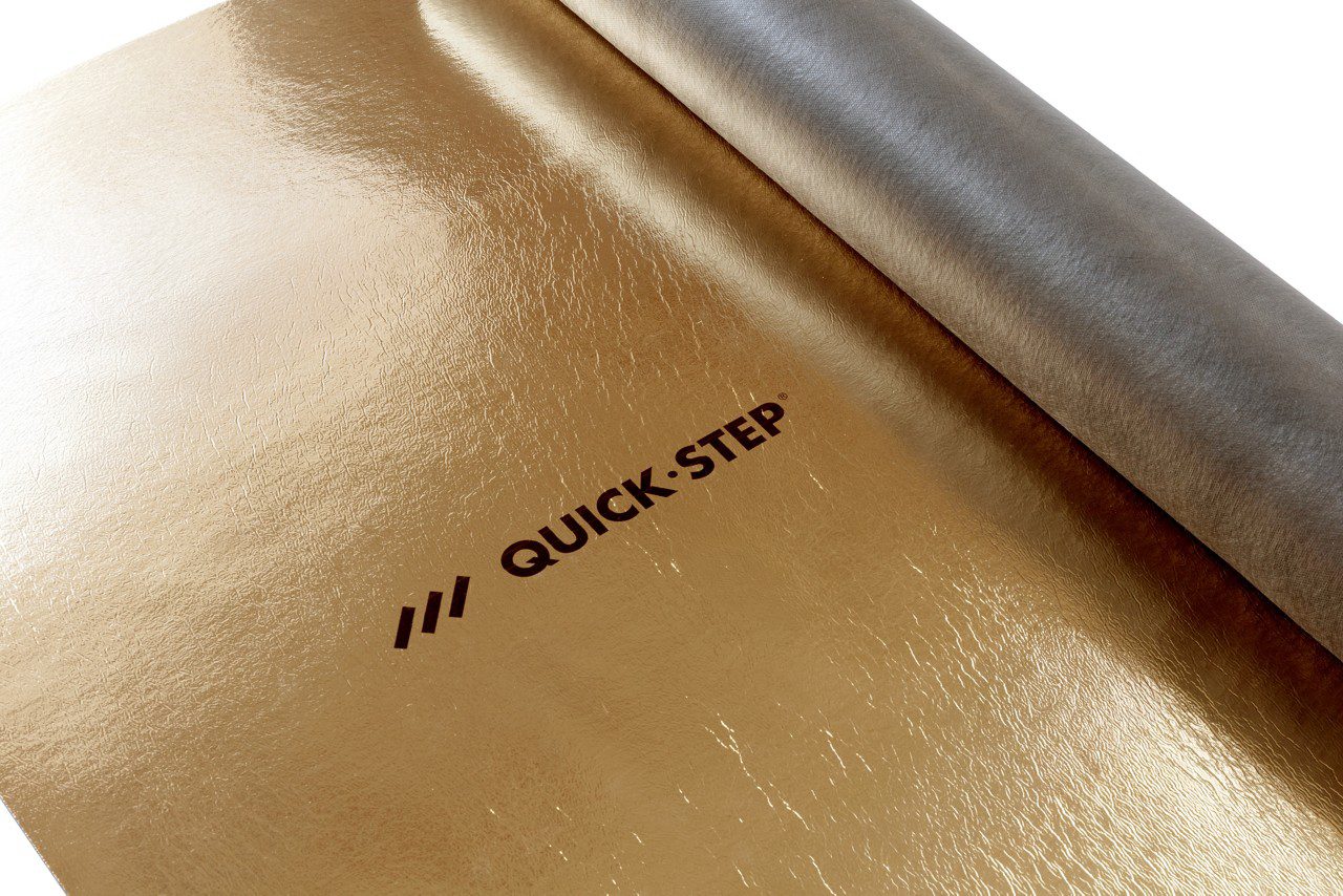 Подложка под ламинат и паркет Quick Step Silent Walk с золотистой пароизоляцией. Рулон наполовину развернут на черновом полу.